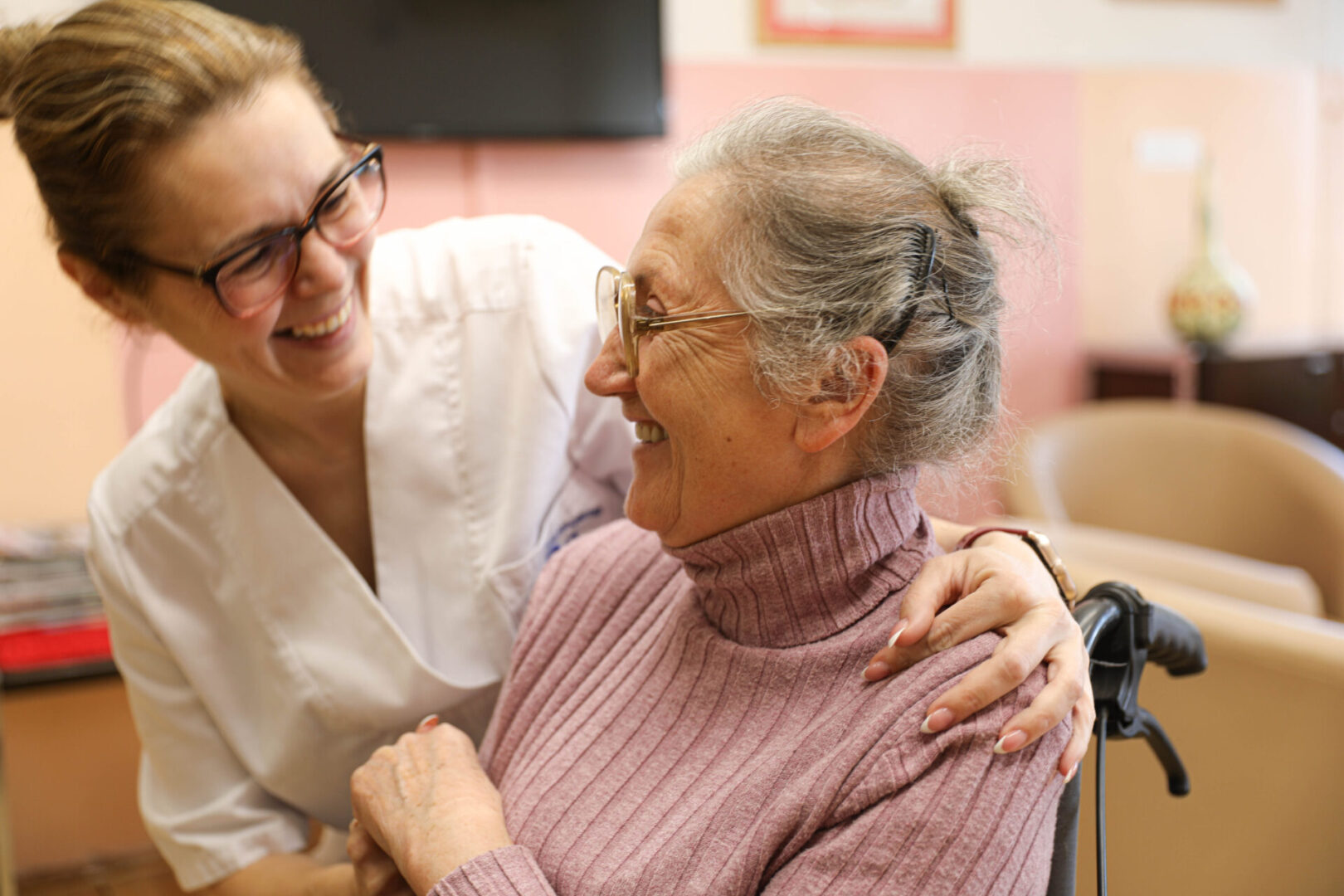 Tender Care: Medical Staff Assisting an Elderly Woman in a Wheelchair