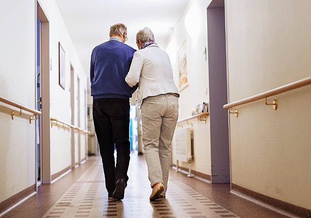 Senior couple walking a corridor in a senior home